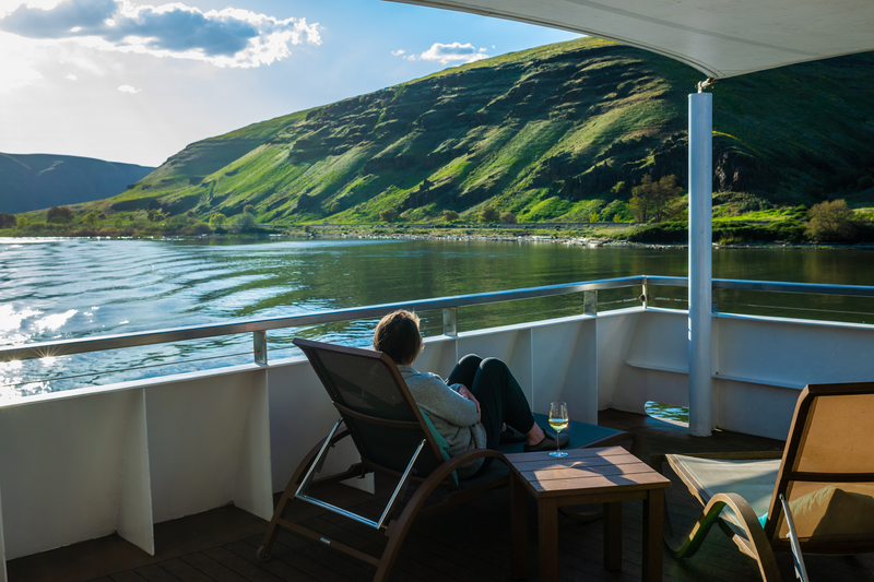 Guests enjoy the sundeck while exploring Snake River onboard National Geographic Quest.