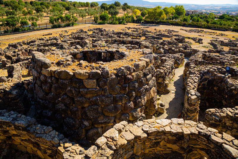 Nuragic ruins of a round tower from the archaeological site of Barumini in Sardinia, Italy