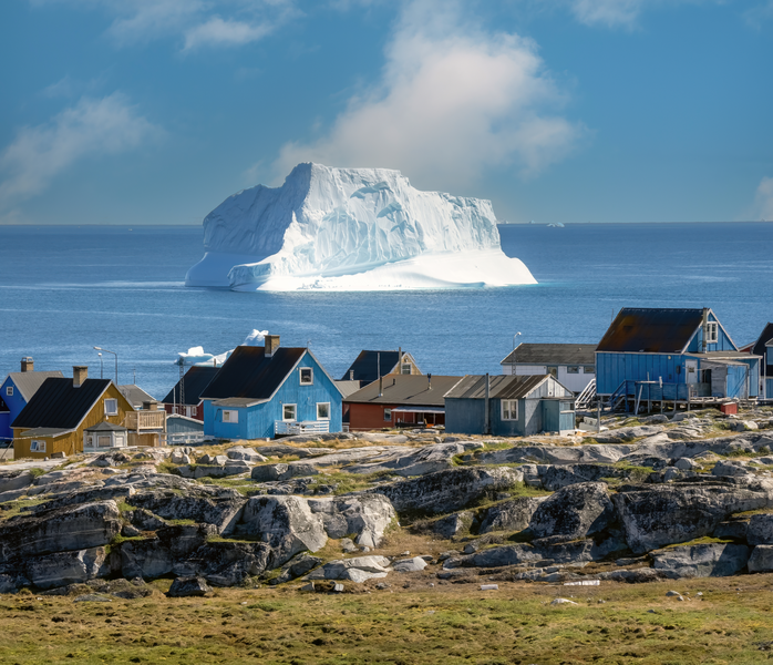 Huge icebergs lining the shores of the charming town of Qeqertarsuaq (formerly Godhavn) on the south coast of Disko Island, Western Greenland.