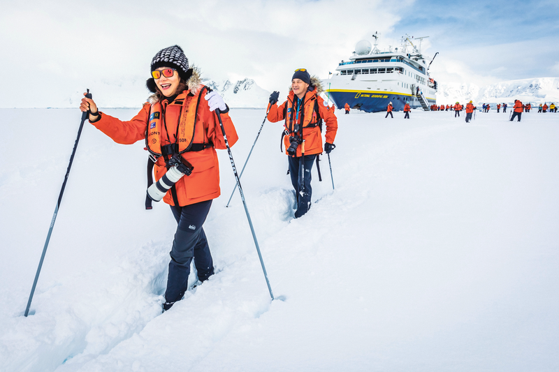 Guests cross-country skiing on the sea Ice from the ship National Geographic Orion, Wilhelmina Bay, Antarctic Peninsula, Antarctica