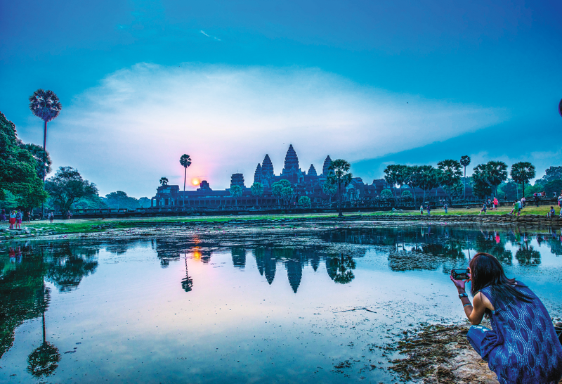 Guest photographing Angkor Wat during Sunrise in Cambodia