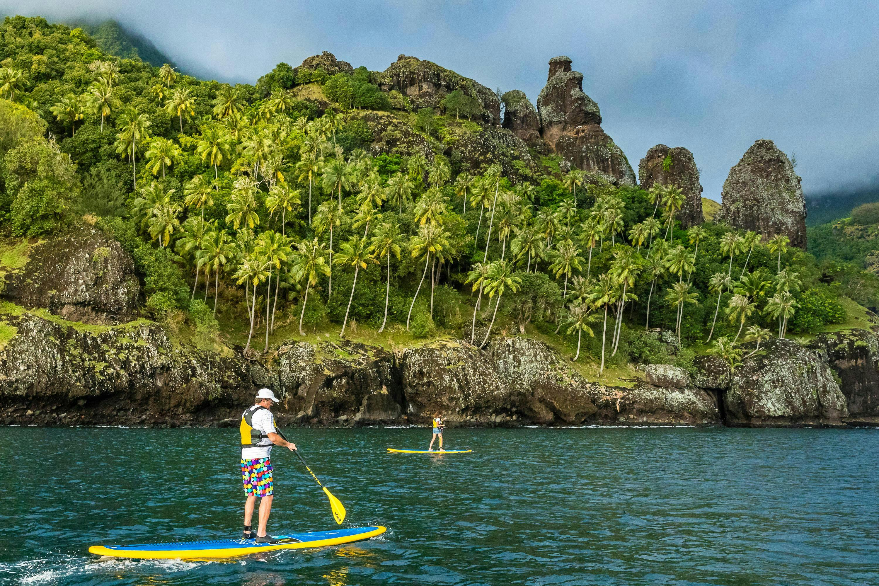 Two guests paddleboard in Futu Hiva, Marquesas Archipelago, French Polynesia