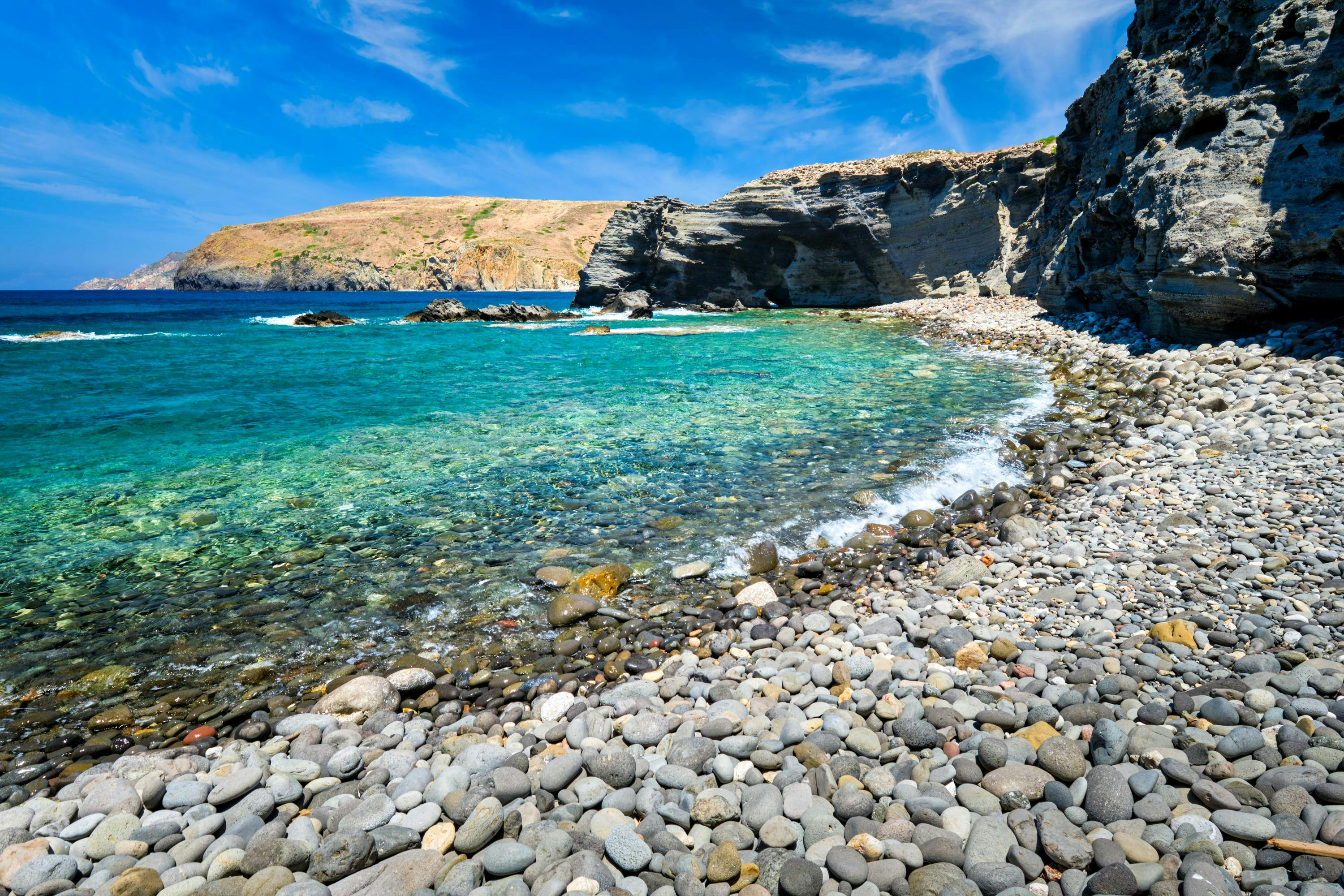 Papafragas beach with crystal clear turquoise water and tunnel rock formations in Milos island, Greece