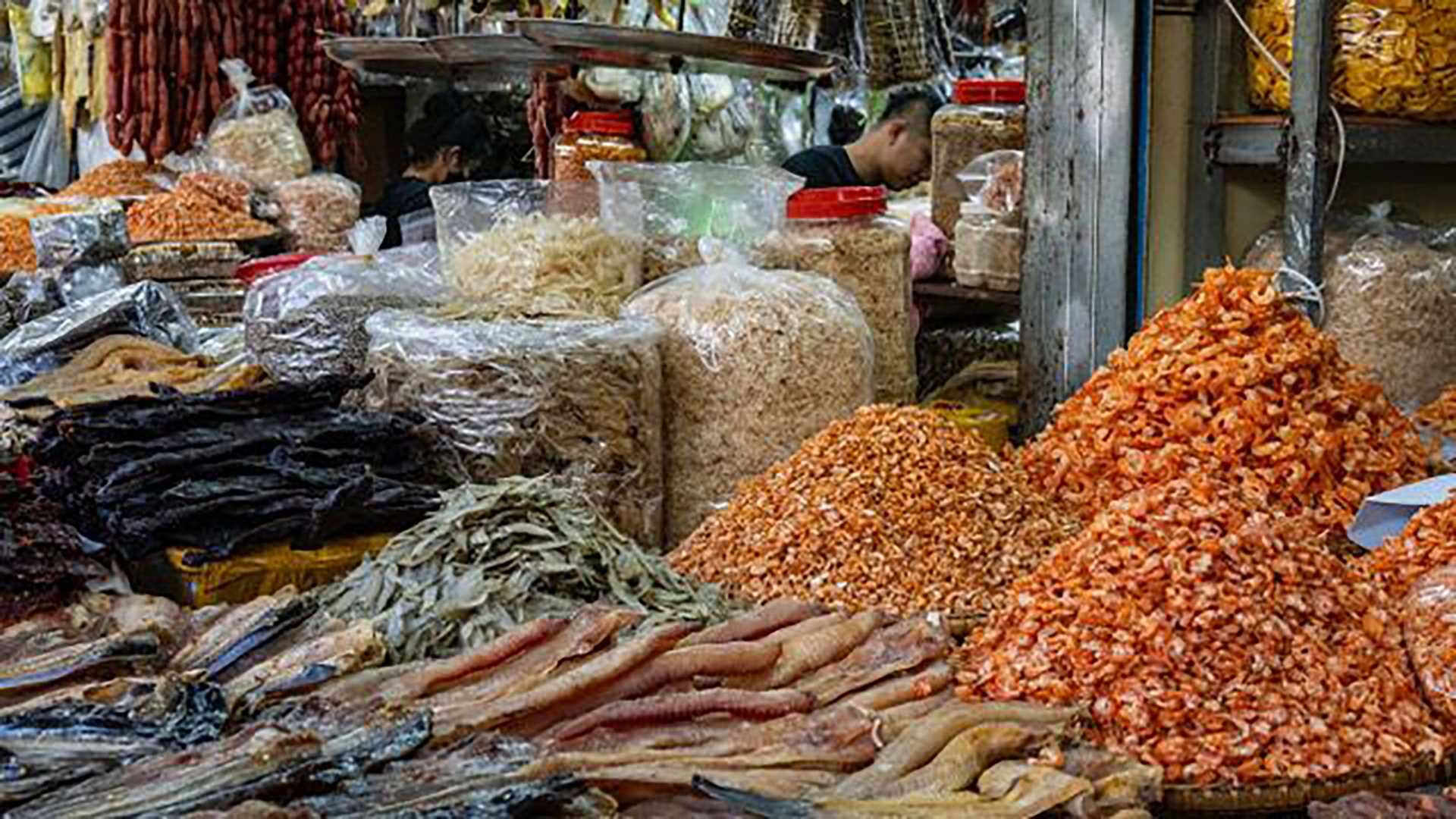 shrimp and fish in piles at an outdoor market