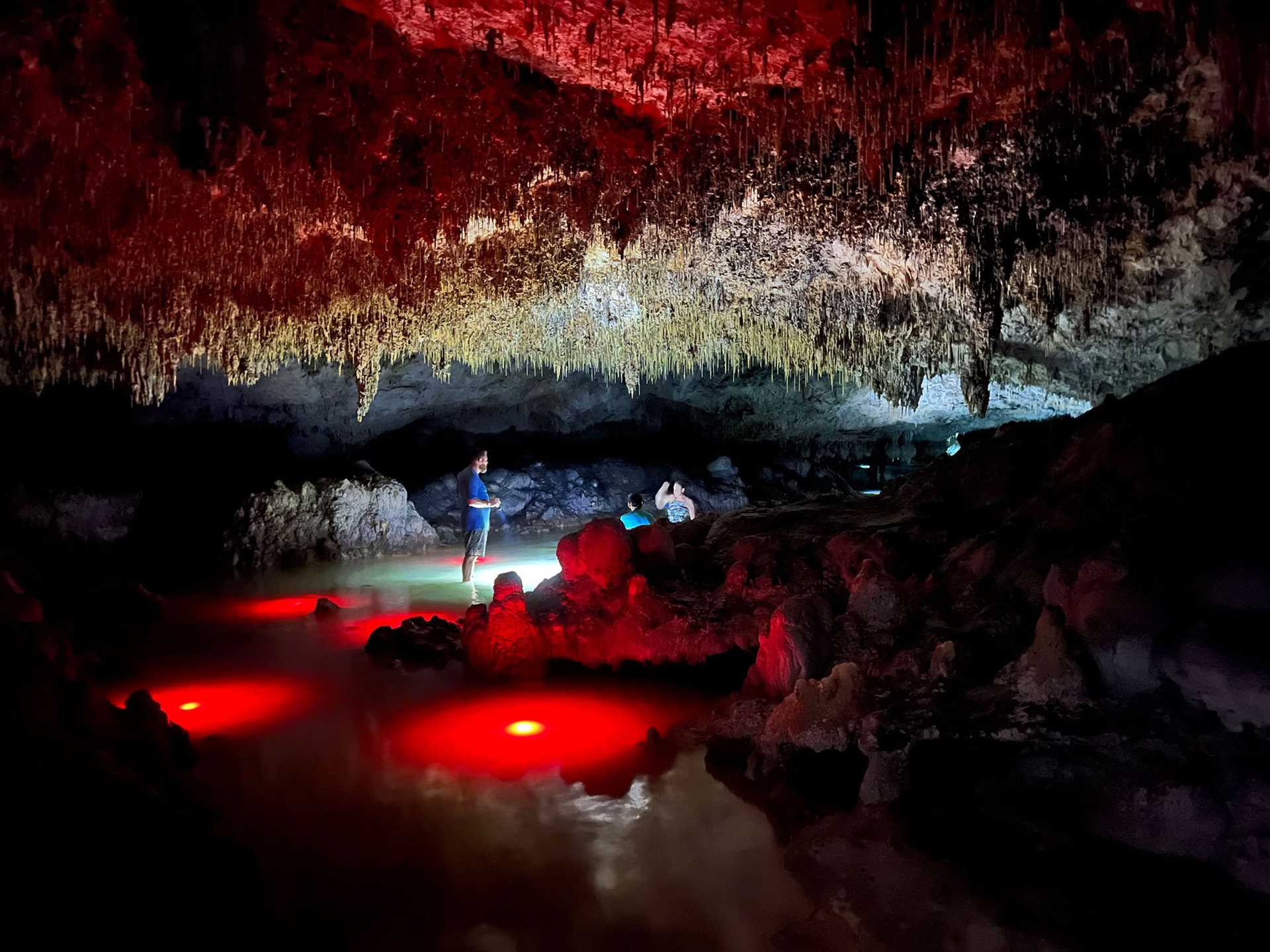 person standing in an underground cave