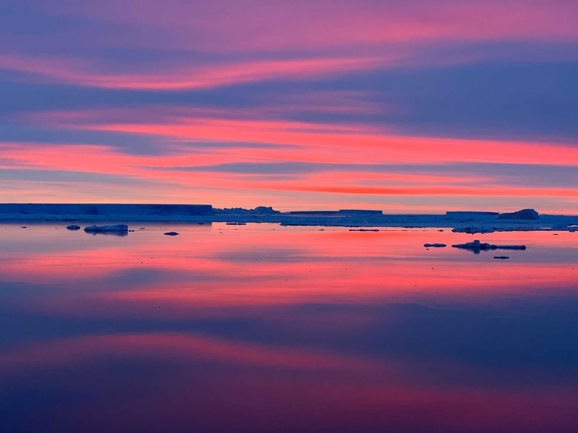 antarctic ice in a pink and purple sunset