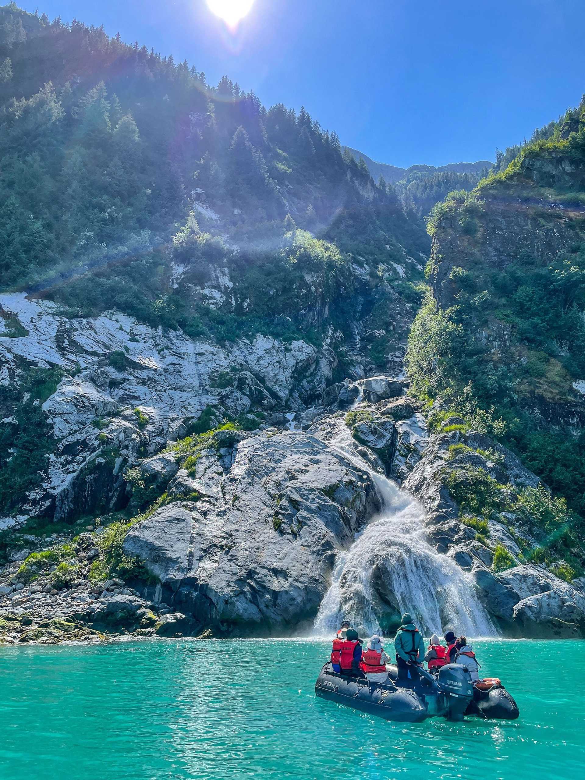 zodiac in front of waterfall and sparkling water