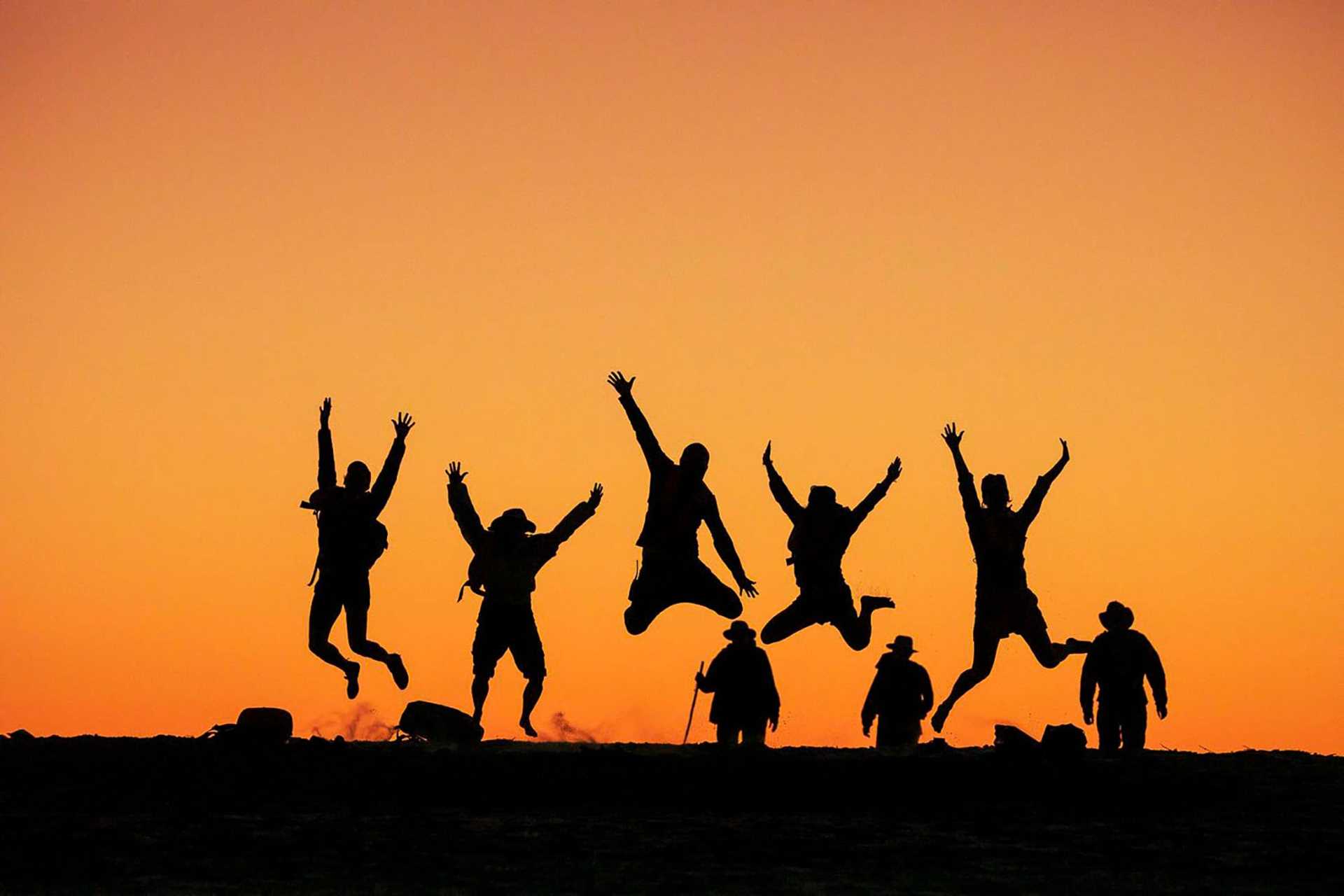 silhouetted jumping people