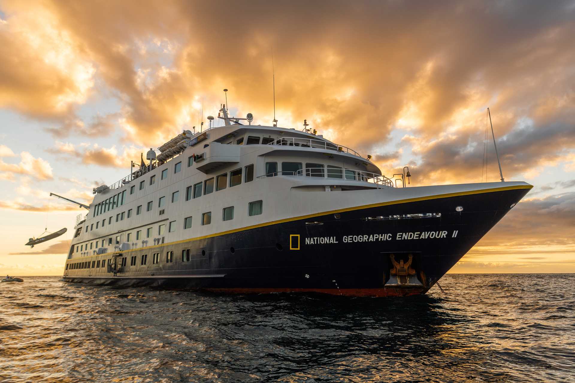 The ship National Geographic Endeavour II anchored at sunset.