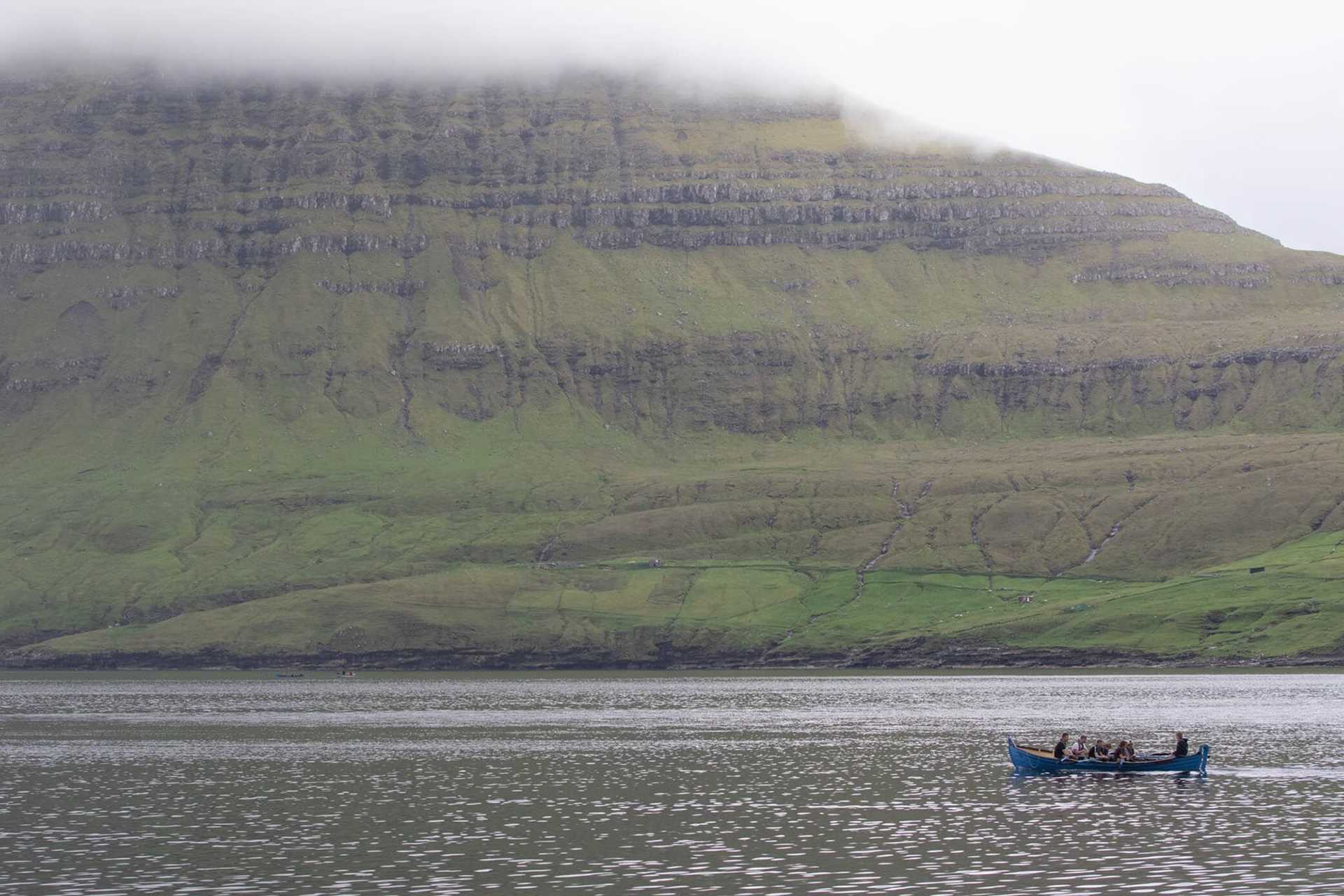 rowers in front of mountain