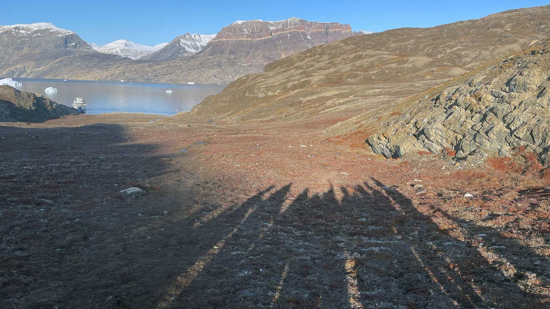 shadows of hikers on a rocky landscape