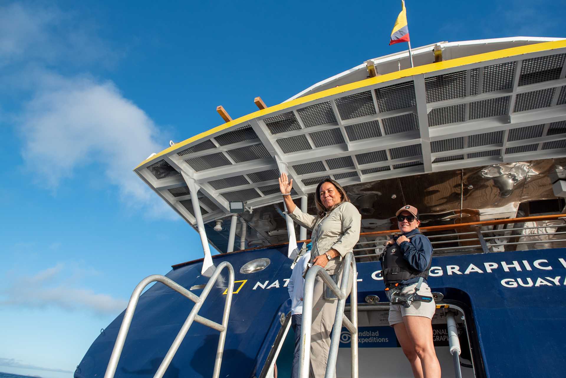 Two naturalists from the National Geographic Islander II greet guests after a Zodiac ride.