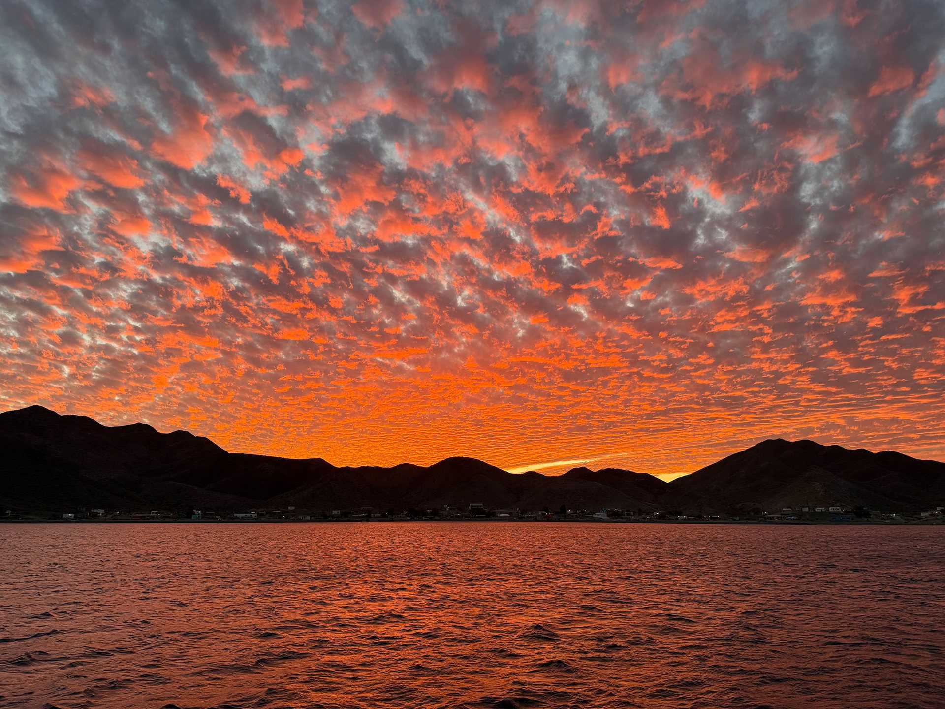 a pink and orange sunset over water