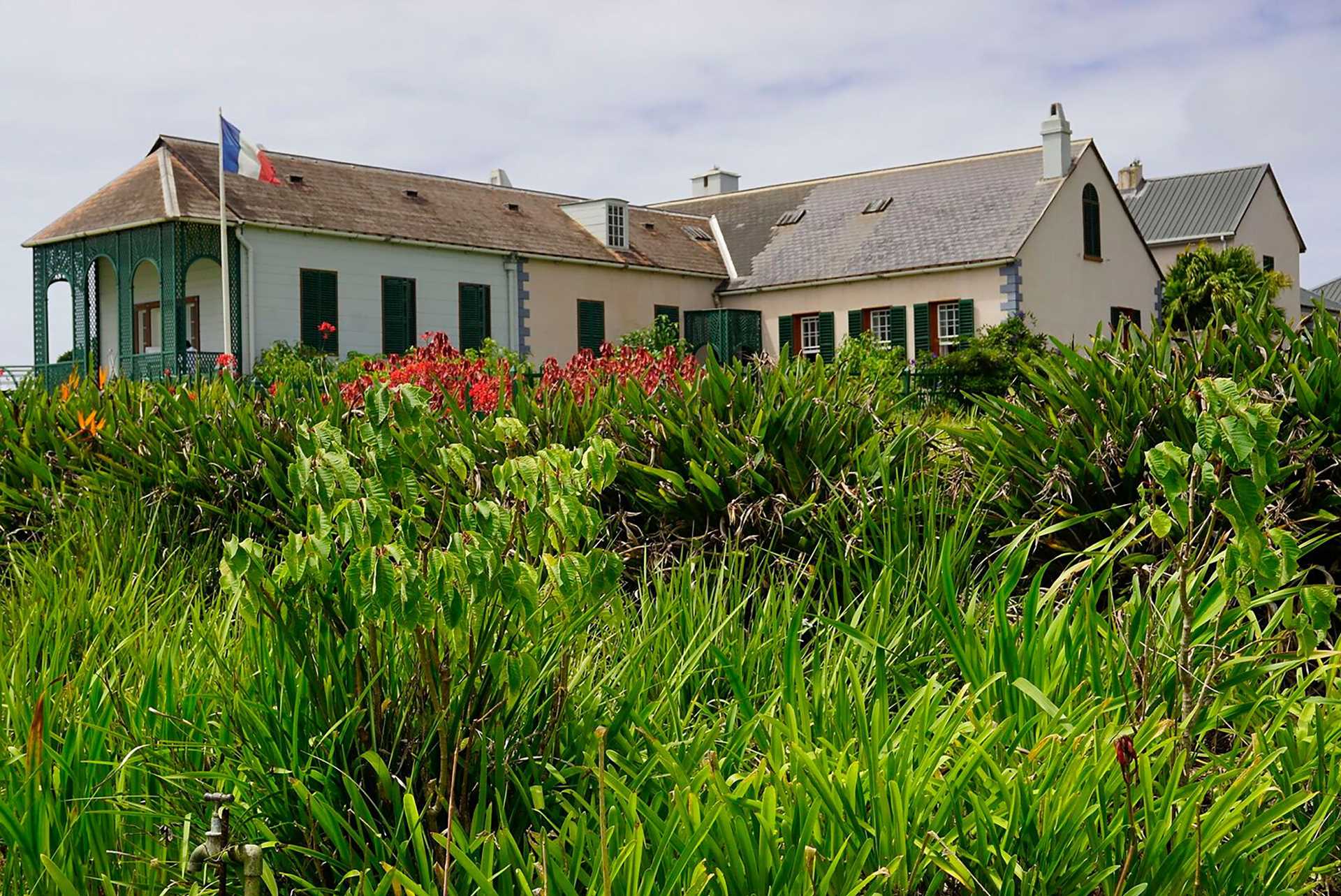 white house on a green hill